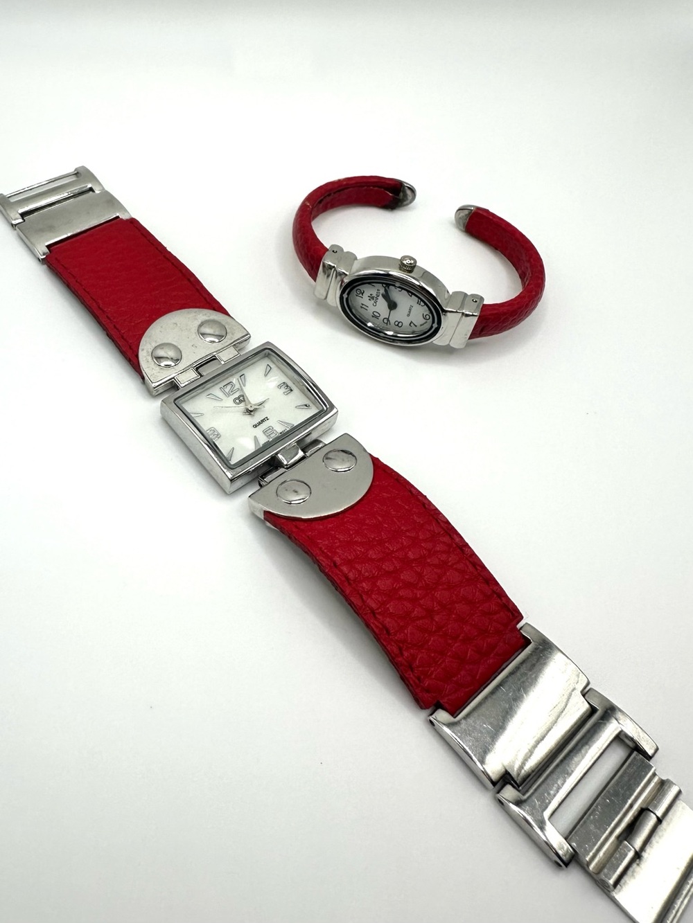 two vintage red watches